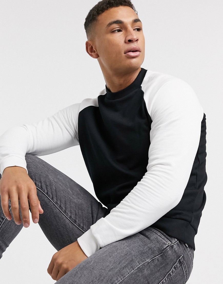 ASOS DESIGN organic sweatshirt in black with white raglan sleeves
