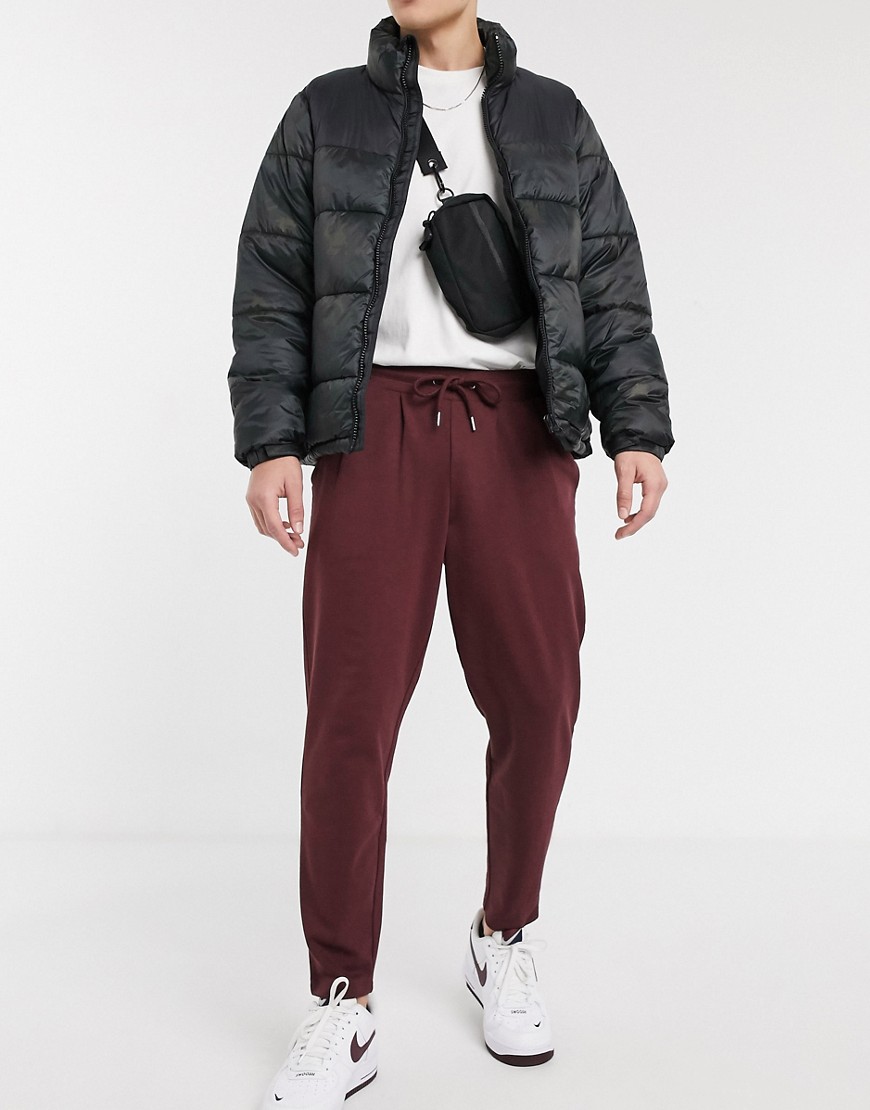 ASOS DESIGN organic tapered joggers with pleats in burgundy
