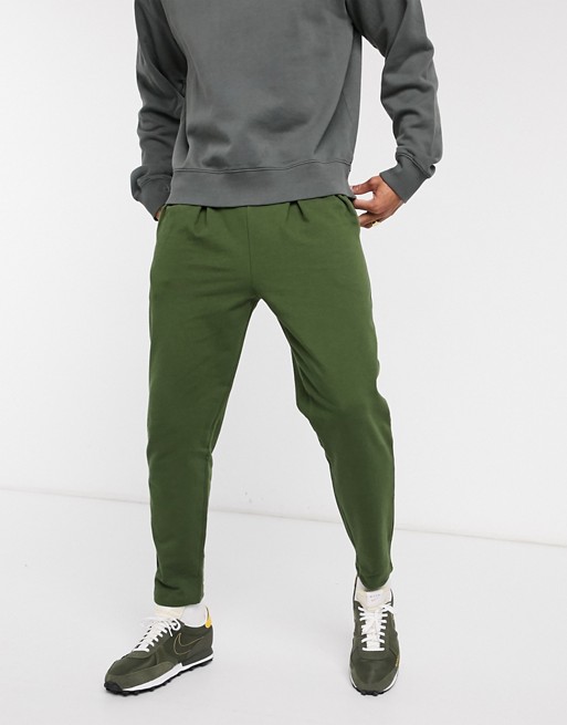 ASOS DESIGN organic tapered sweatpants with pleats in green | ASOS