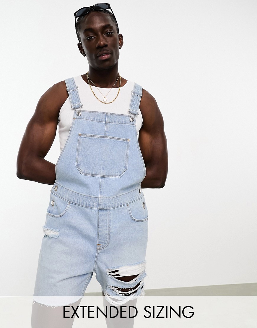 overalls in light wash blue with heavy rips in shorter length