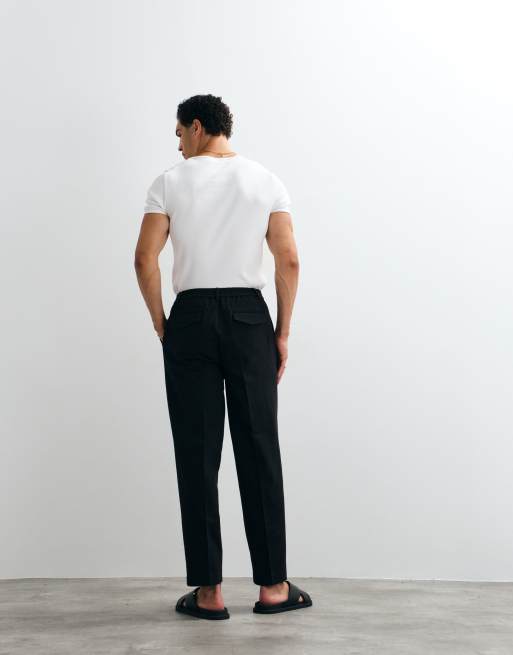 ASOS DESIGN oversize avsmalnande byxor i denimlook, smart set, med halv elastisk midja i svart, 4 av 5