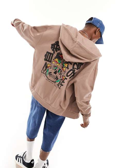 ASOS DESIGN – Oversize-Kapuzenjacke in Braun mit Totenkopf-Schaumprint auf Vorder- und Rückseite