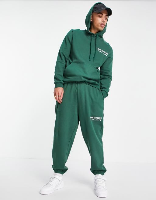 ASOS DESIGN – Oversize-Kapuzenpullover in Dunkelgrün mit Wellness-Textdruck, Kombiteil – MGREEN – MGREEN