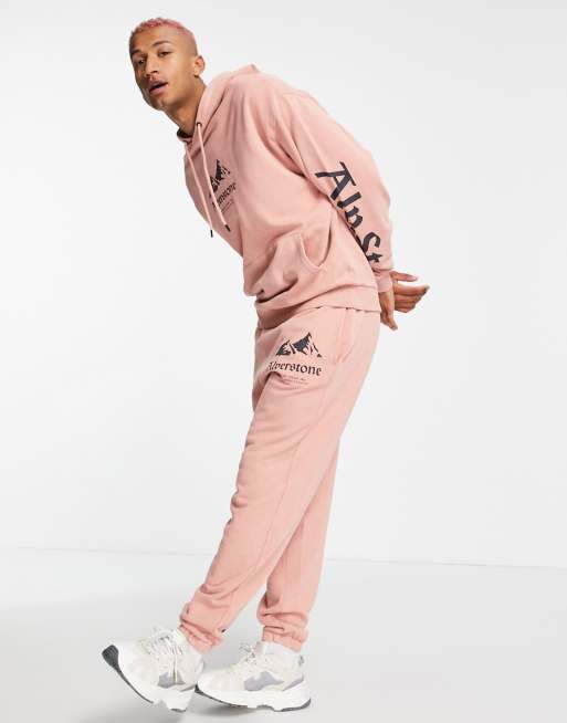 ASOS DESIGN – Oversize-Kapuzenpullover in rosa Waschung mit aufgedrucktem Bergmotiv und Text, Kombiteil