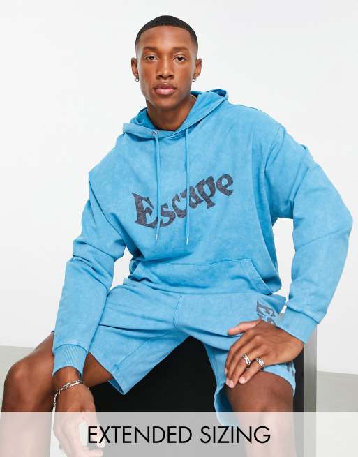 ASOS DESIGN – Oversize-Kapuzenpullover mit Acid-Waschung in Blau und Textprint, Kombiteil