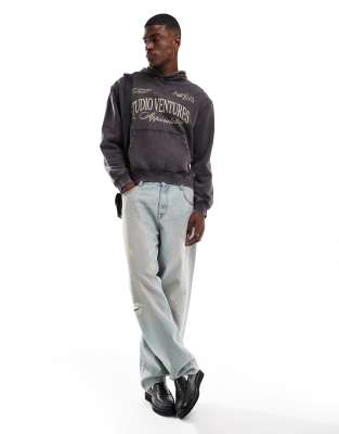 ASOS DESIGN oversized acid wash hoodie with front chest print in gray
