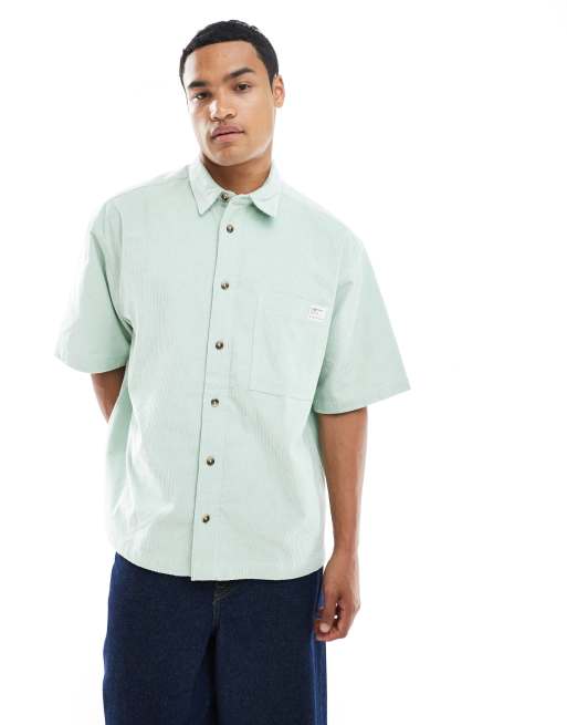 ASOS DESIGN oversized cord shirt with badge in green