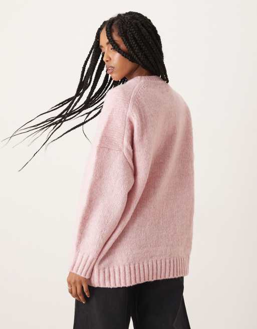 ASOS DESIGN oversized crew neck jumper with curved hem in pink
