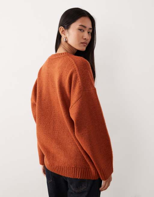 ASOS DESIGN oversized crew neck sweater with curved hem in rust