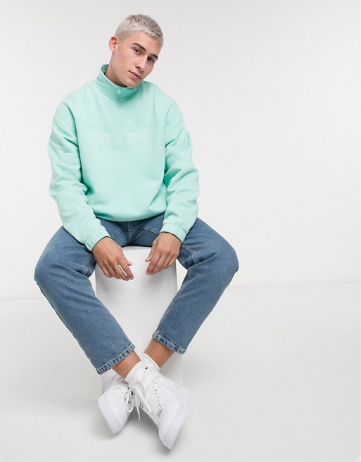 ASOS DESIGN oversized half zip sweatshirt with text print