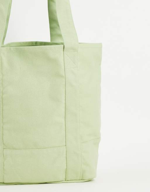 ASOS DESIGN tote bag in pastel green with collegiate print