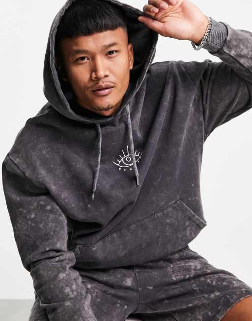 ASOS DESIGN oversized hoodie in black acid wash with mystic back