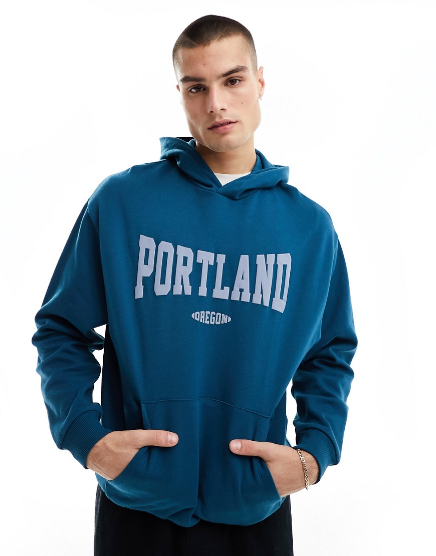 ASOS DESIGN oversized hoodie in dark blue with puff print city text
