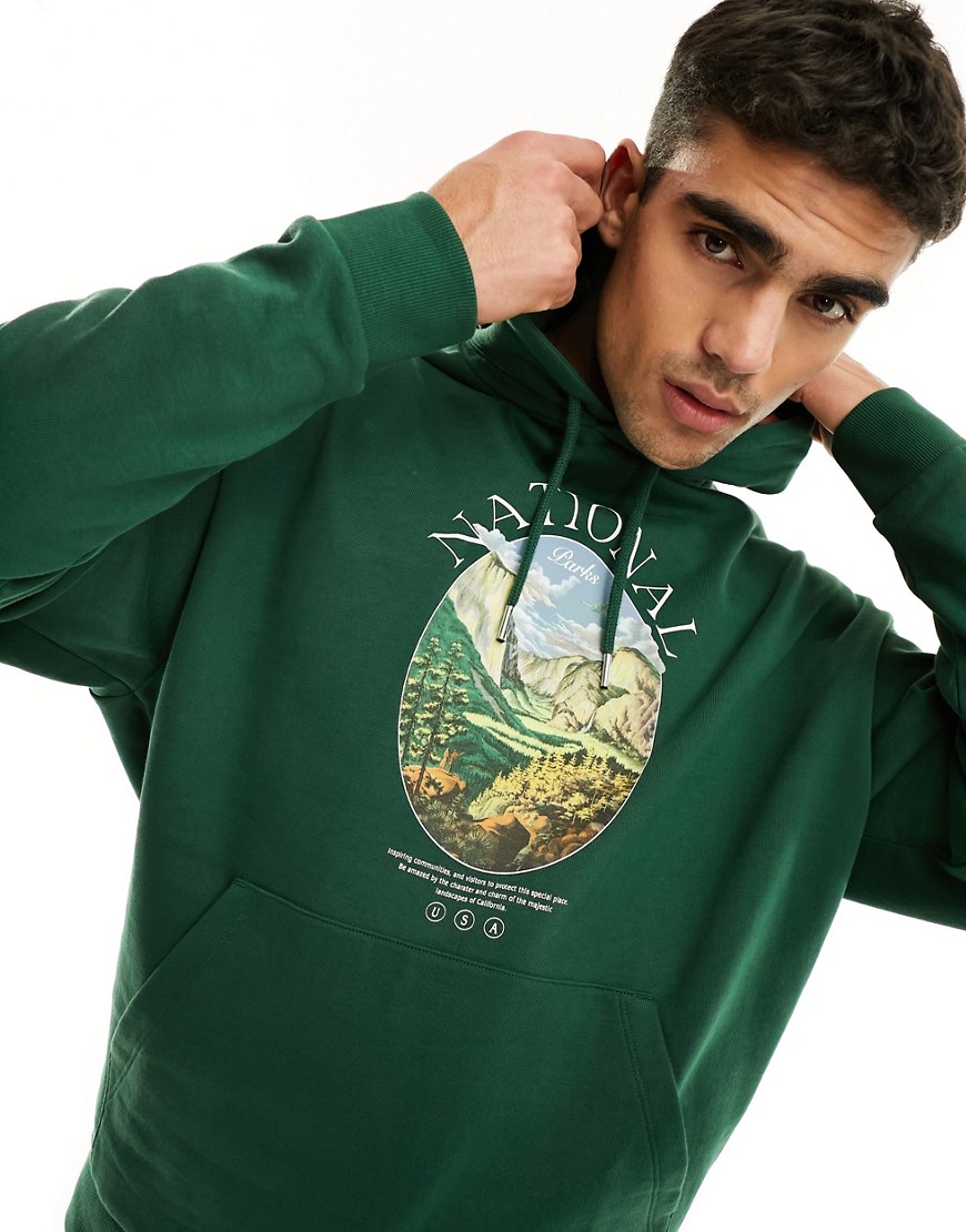 ASOS DESIGN oversized hoodie in dark green with photographic outdoors print & sleeve embroidery