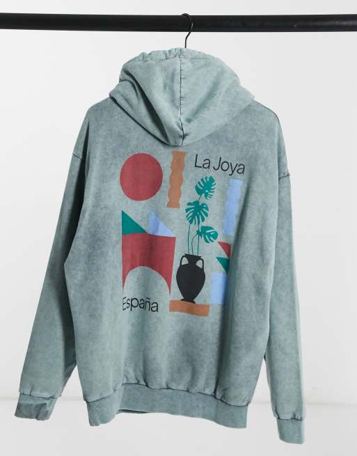 ASOS DESIGN oversized hoodie in green acid wash with Spanish graphic back print