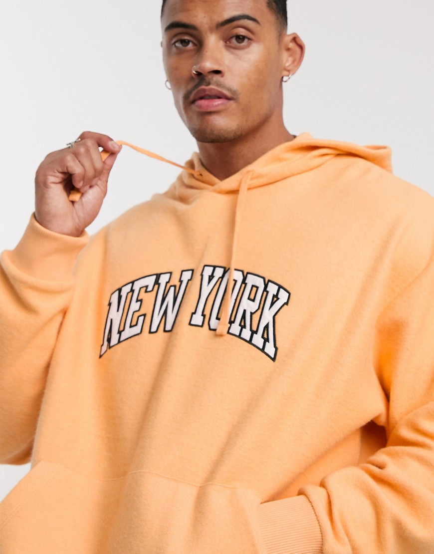 ASOS DESIGN oversized hoodie in orange reverse fleece with New York embroidery