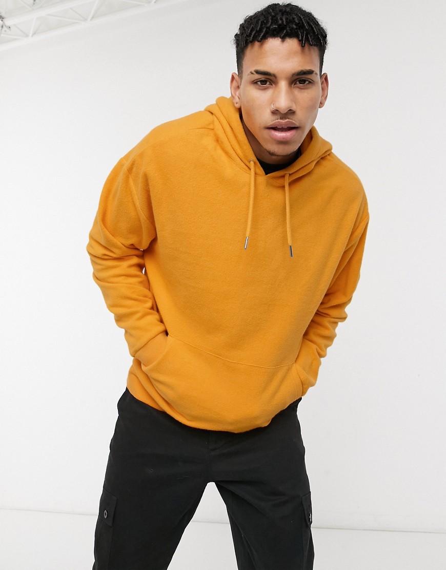 ASOS DESIGN oversized hoodie in orange with fleece lining