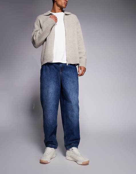 ASOS DESIGN – Oversized-Jeans in dunkler Waschung mit schmal zulaufendem Bein und Bundfalten - view 1