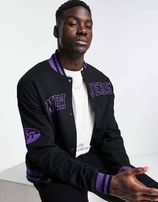 ASOS DESIGN oversized varsity bomber jacket in black with purple badging