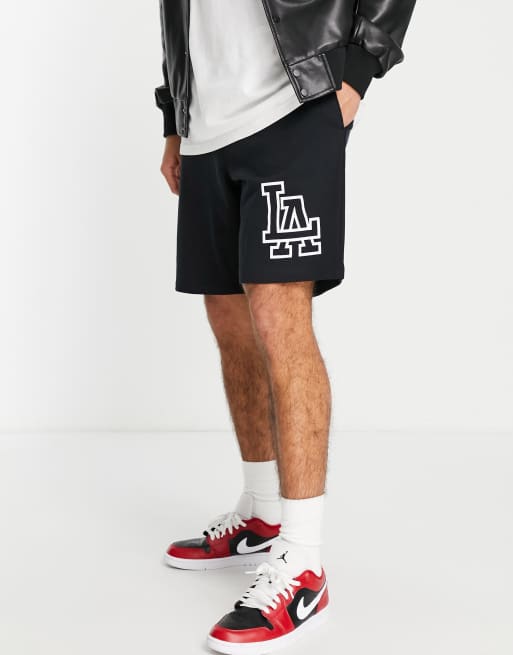 ASOS DESIGN oversized jersey shorts in black with LA city print