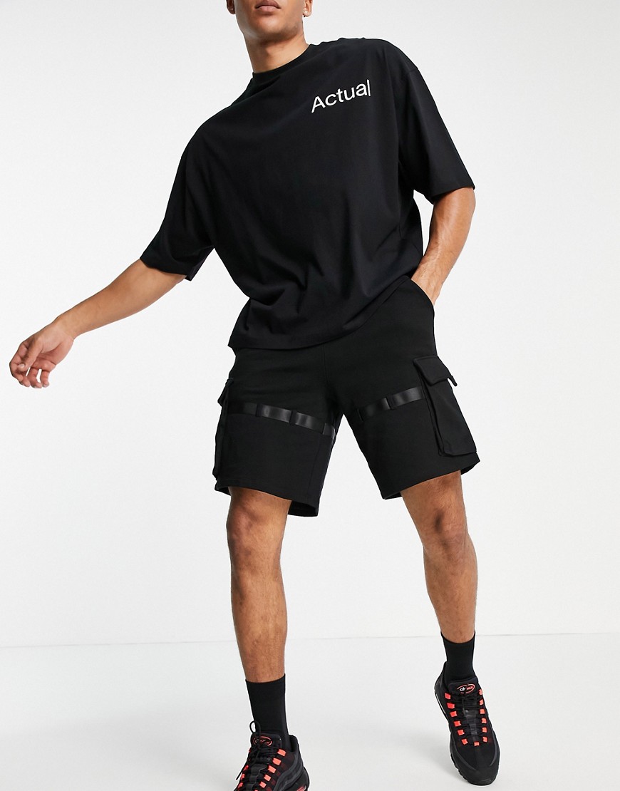 ASOS DESIGN oversized jersey shorts in black with multi pockets & strapping detail