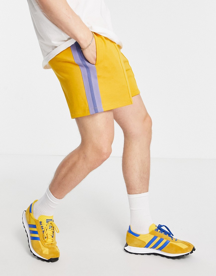 ASOS DESIGN oversized jersey shorts with pin tucks & side tape in mustard yellow