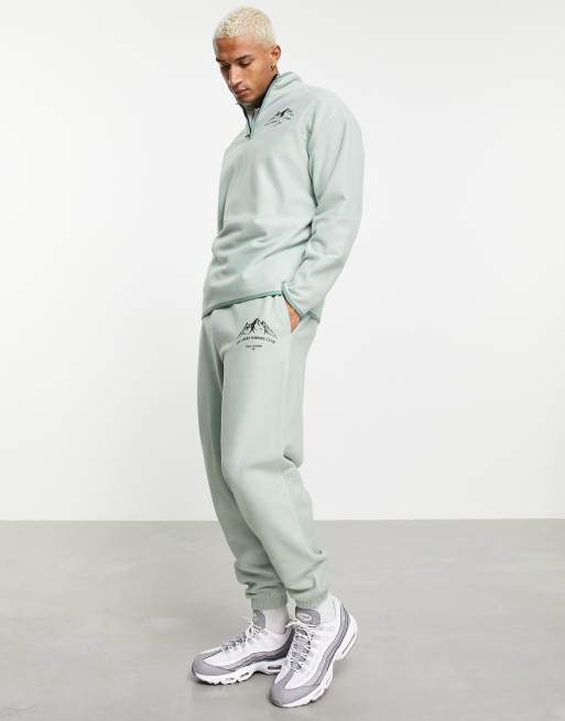 ASOS DESIGN oversized jogger in green polar fleece with mountain print