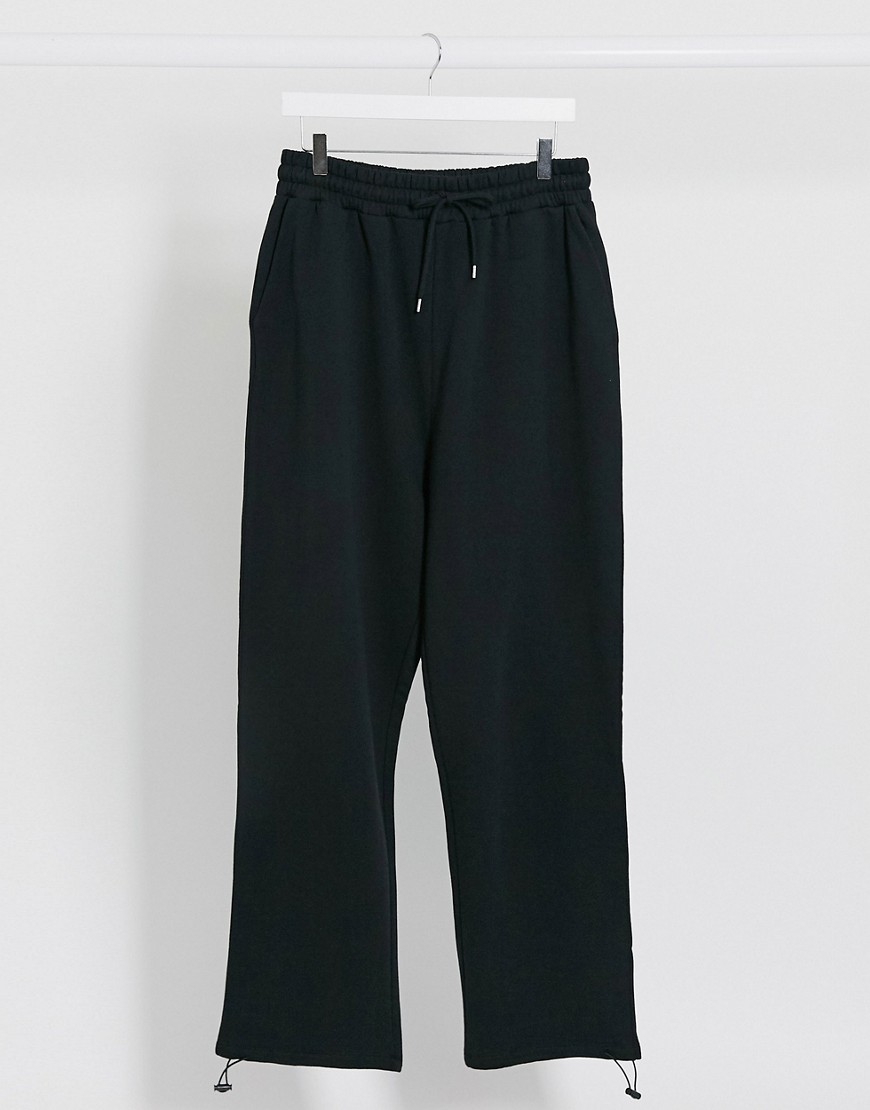 ASOS DESIGN oversized joggers in black with toggle hem