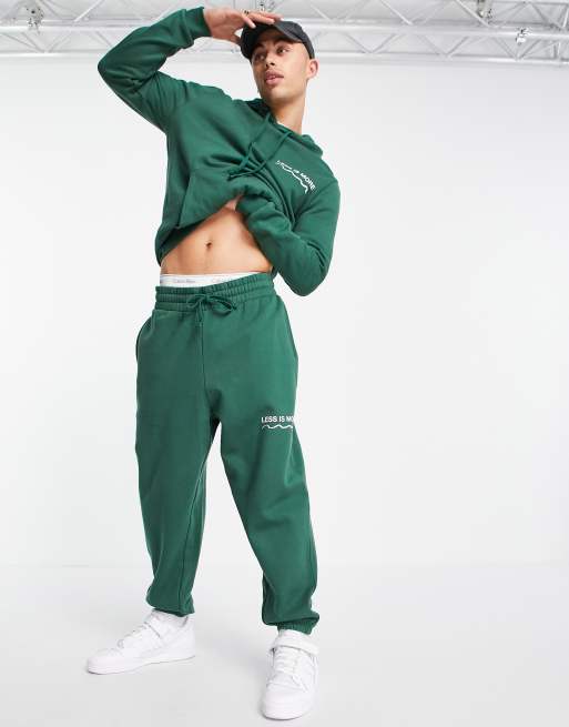 ASOS DESIGN - Oversized joggers in donkergroen met wellness tekstprint, deel van co-ord set - MGREEN - MGREEN