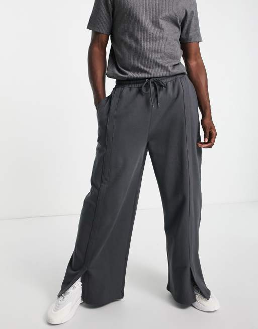 ASOS DESIGN - Oversized joggingbroek met wijde pijpen en split aan de voorkant in zwart met wassing, deel van combi-set 