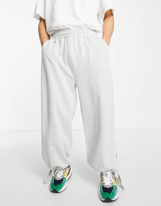 ASOS DESIGN - Oversized joggingbroek met wijde pijpen en strikbandjes aan de zijkant in lichtgrijs
