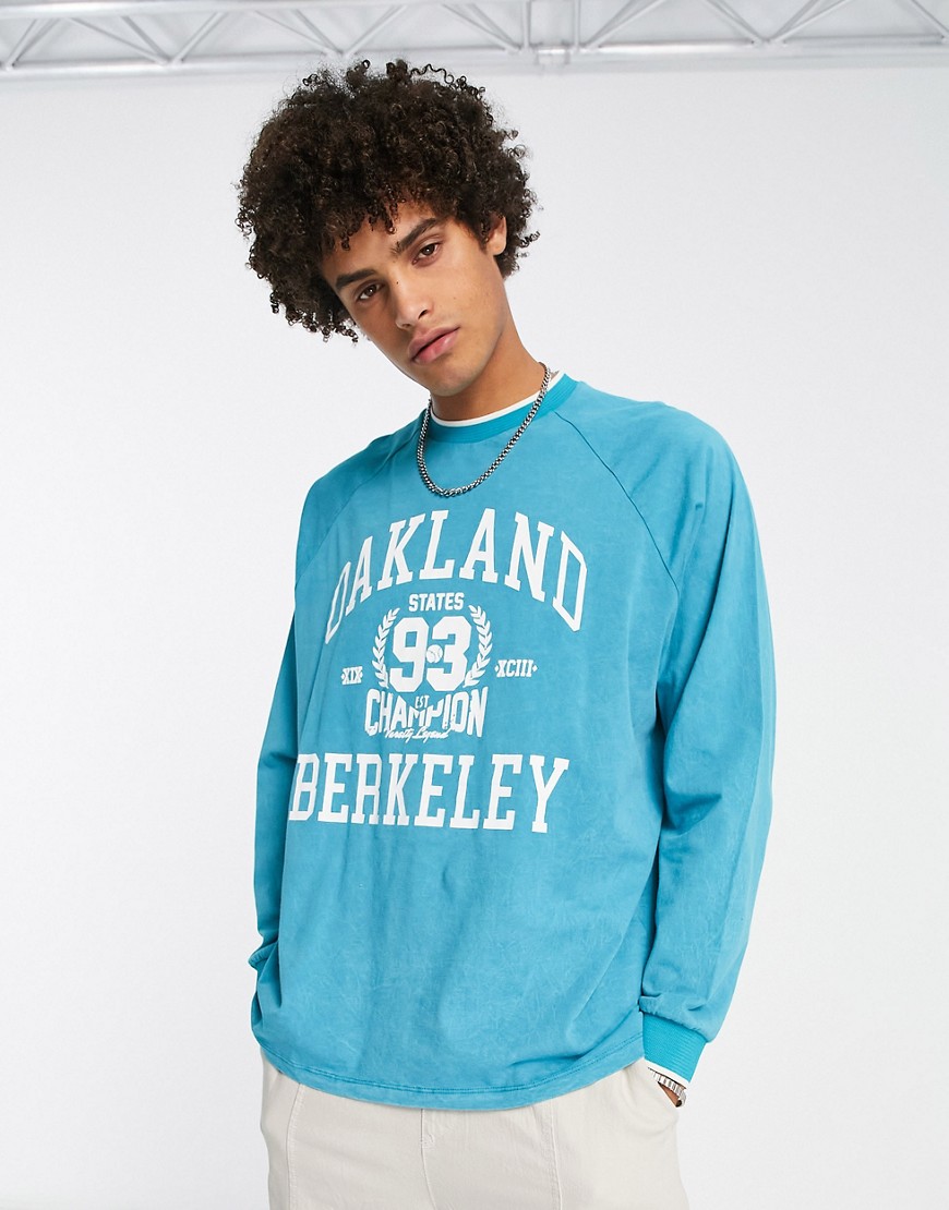 ASOS DESIGN oversized long sleeve t-shirt in washed blue with collegiate print and tipping