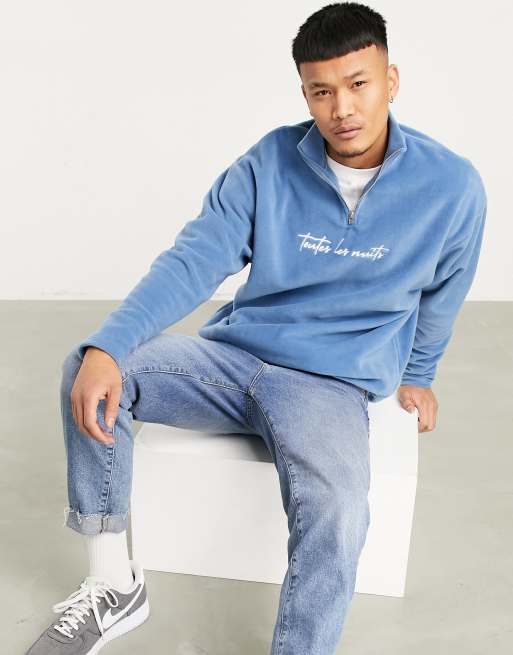 ASOS DESIGN oversized polar fleece half zip sweatshirt with chest  embroidery in mid wash blue