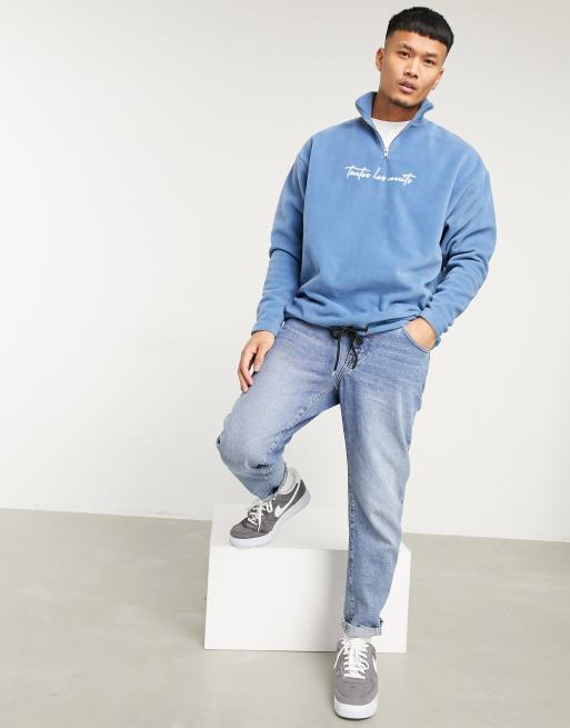 ASOS DESIGN oversized polar fleece half zip sweatshirt with chest  embroidery in mid wash blue