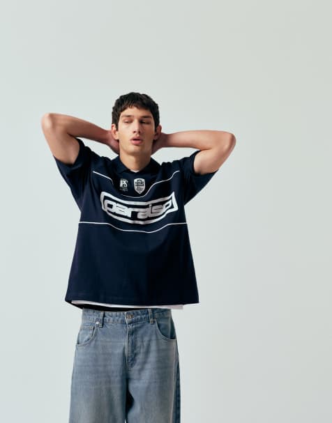 ASOS DESIGN oversized polo t-shirt with panels and paraiso graphic in navy