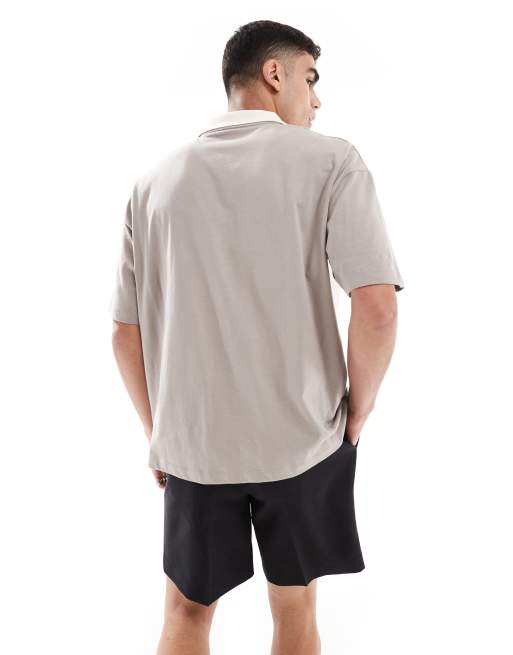 ASOS DESIGN oversized polo with cut and sew paneling and text graphic in brown