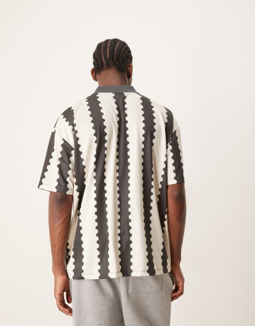 ASOS DESIGN oversized polo with sports graphic and all over print