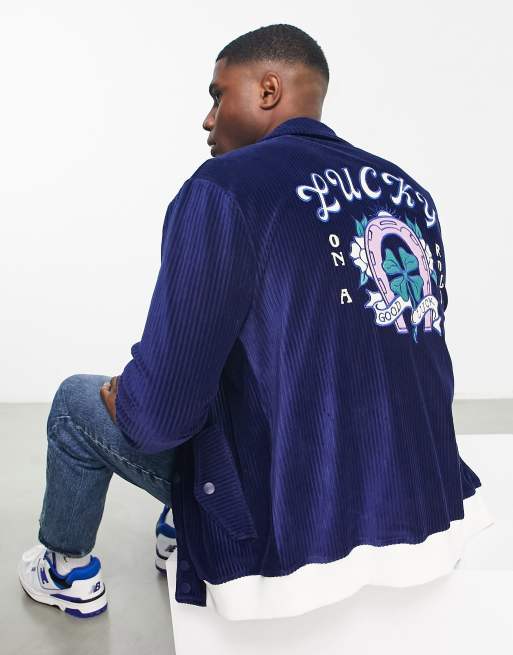 ASOS DESIGN oversized varsity jacket with badges in blue