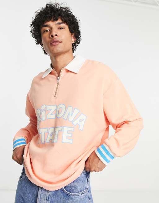 ASOS DESIGN oversized rugby sweatshirt in peach with city print