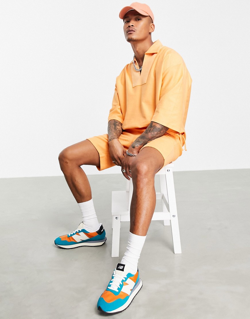 ASOS DESIGN oversized short sleeve sweatshirt with pocket in orange - part of a set
