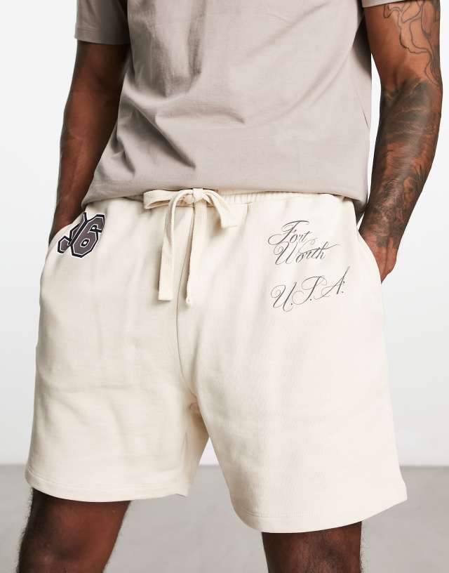 ASOS DESIGN oversized shorts in beige with text print