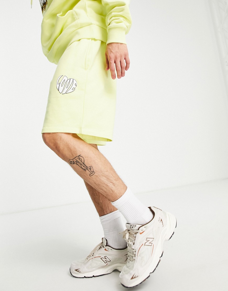 ASOS DESIGN oversized shorts in yellow with small love print - part of a set