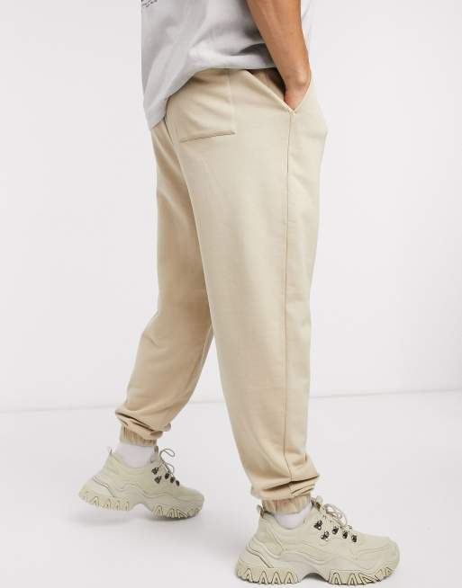 ASOS DESIGN oversized tapered joggers with knee detail in beige