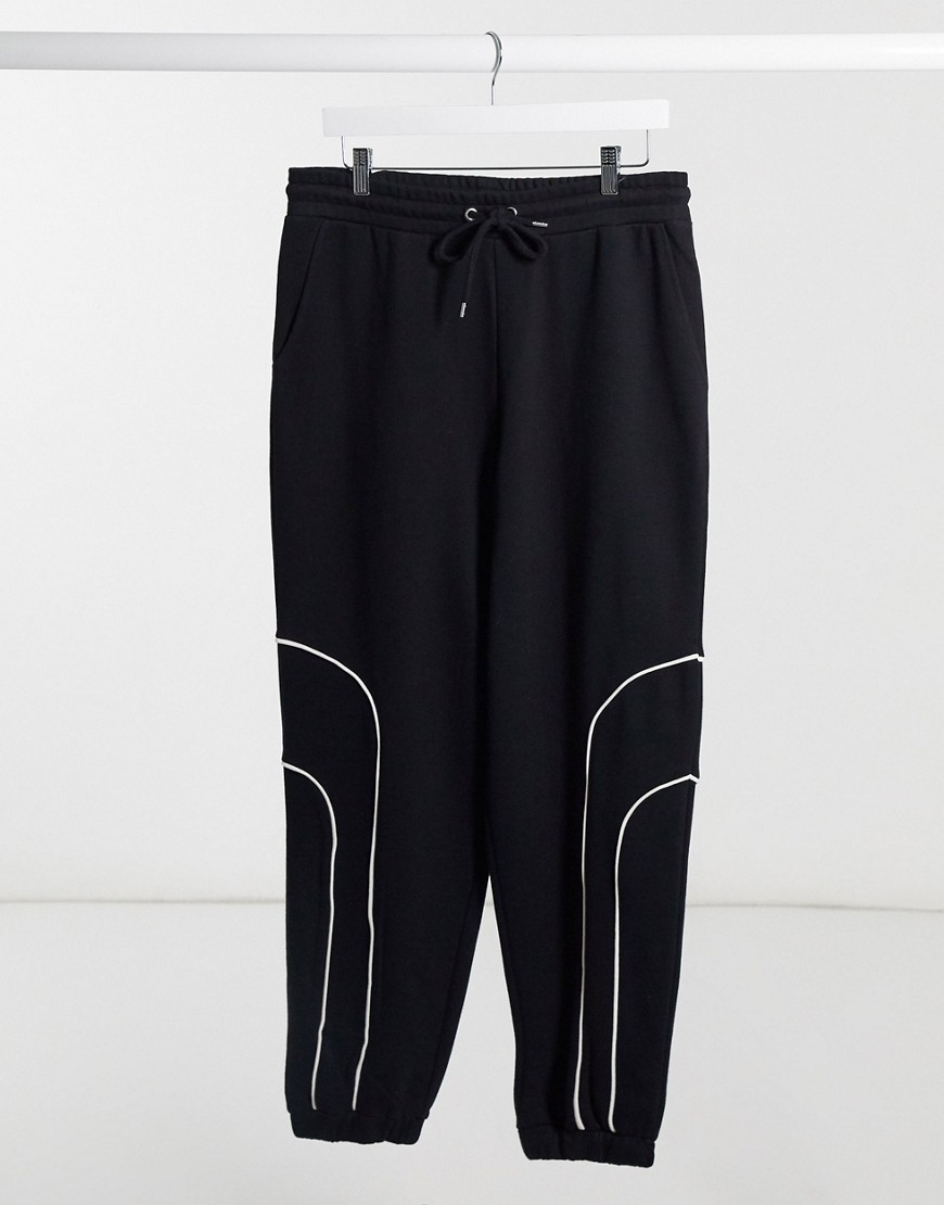ASOS DESIGN oversized sweatpants in black with bungee details and piping