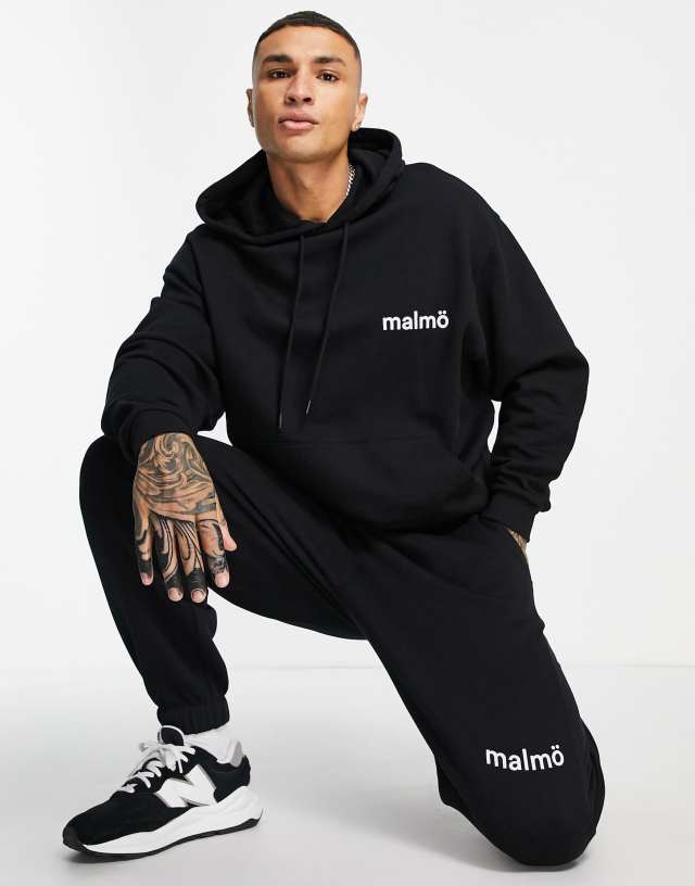 ASOS DESIGN oversized sweatpants in black with Malmo city print - part of a set