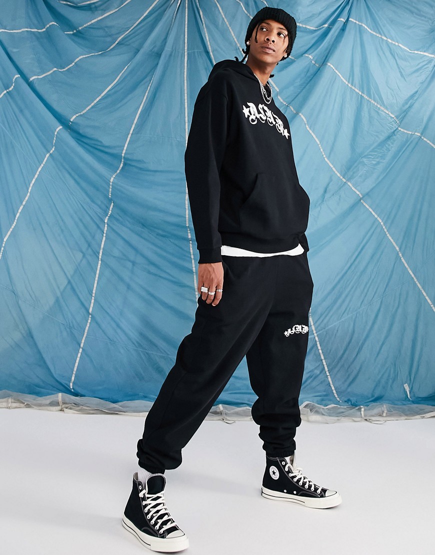 ASOS DESIGN oversized sweatpants in black with text print - part of a set