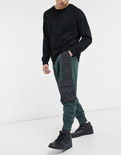 ASOS DESIGN oversized sweatpants in deep green with washed black nylon ...
