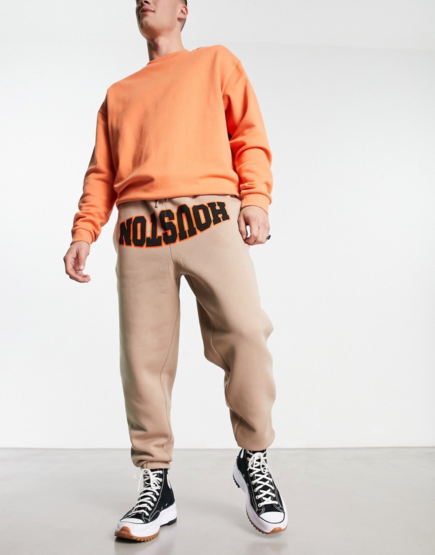 ASOS DESIGN oversized sweatpants with collegiate text print-Neutral