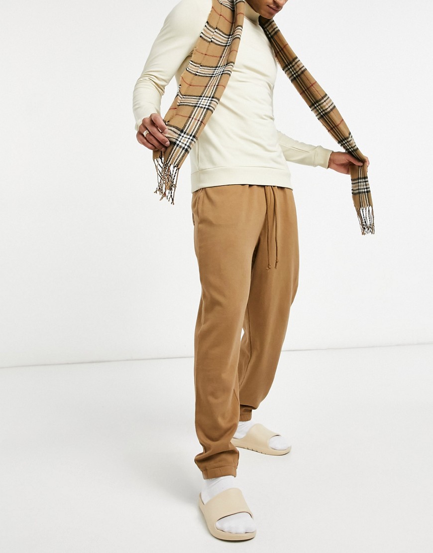 ASOS DESIGN oversized sweatpants with narrow waistband in washed brown