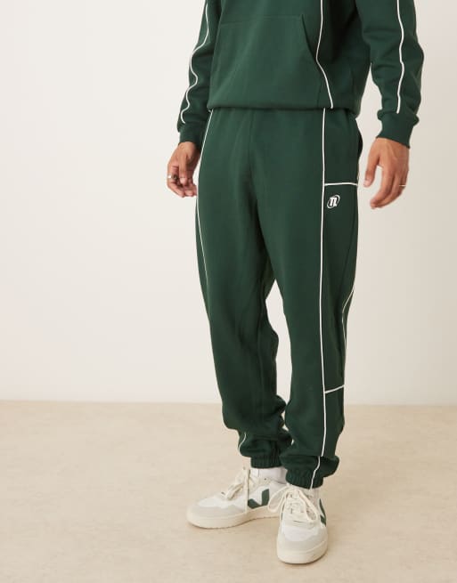 ASOS DESIGN oversized sweatpants with piping and print in green - part of a set